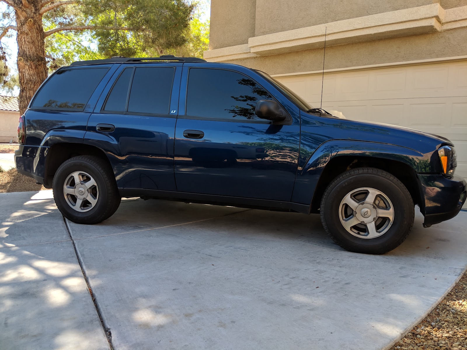 Blue Chevrolet TrailBlazer SUV with tinted windows in a driveway